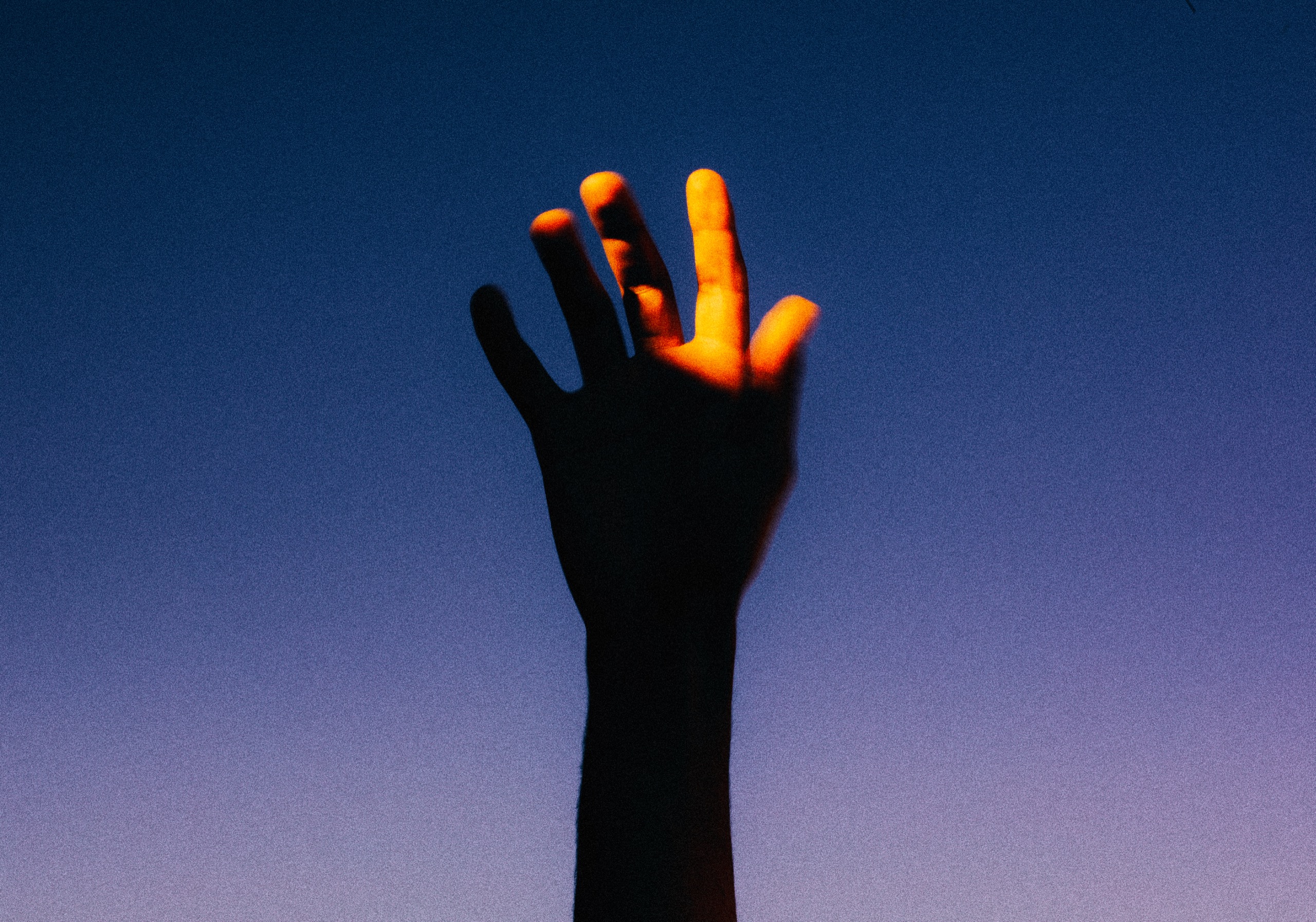 Hand reaching toward the light